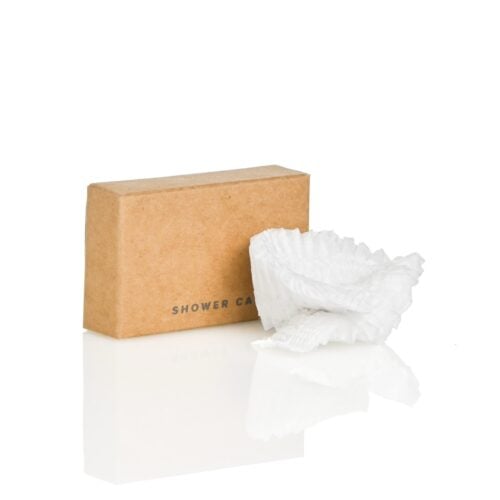 Contemporary Collection corn-starch shower cap in recycled kraft box for hospitality use.