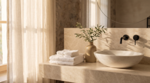 Boutique guest bathroom vanity with amenity tray and folded towels